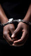 © Curioso.Photography - Hands of a person in handcuffs against a dark background symbolizing arrest, crime and justice.
