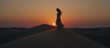© takayuki_n82 - Authentic woman walking gracefully across a desert dune at sunset in minimal style