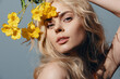 © VICHIZH - Beautiful young model with long blonde hair and flowers, exuding natural elegance in a soft, warm color palette. Perfect for fashion and beauty themes.