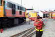© arrowsmith2 - African Railway Technician Coordinating Train Movements at Station Depot