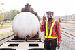 © arrowsmith2 - Friendly African Logistics Officer Using Walkie-Talkie at Railway Cargo Depot