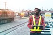© arrowsmith2 - African Logistics Supervisor Monitoring Freight Train Operations at Depot