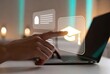 © Hasibnikon - Hand touching graduation cap icon on laptop screen, online education concept, digital learning
