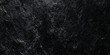 © Daiyan - Abstract black wall texture background with rough slate surface deep shadows, highlights on jagged edges.