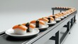 © maxximmm - The sushi conveyor belt features plates of sushi, showcasing a variety of colorful sushi pieces. Each plate has distinct sushi types, with salmon sushi and nigiri prominently displayed.