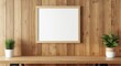 © The 2R Artificiality - Blank poster template hanging on empty frame above wooden wall desk for photo use