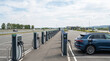 © Cihat - Electric Car Charging At Large Highway EV Fast Charging Hub With Multiple Charging Stations Supporting Clean Energy Transportation