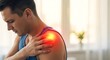 © SD AI - A man in a blue tank top touches his sore shoulder with a red glowing pain spot on it indoors.