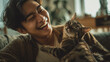 © Broccolini - ultra realistic person playing with cat using feather toy in modern living room, interactive pet play and bonding moment with ginger tabby cat, cozy indoor lifestyle photography of animal enrichment