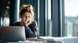 © Broccolini - female student studying with laptop in library, focused college student learning online, young woman studying at desk with laptop and books