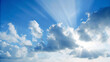 © PixelCraft Studio - Dramatic blue sky with sun rays shining through fluffy white clouds