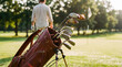 © Aurora Aesthetics - Vintage brown leather golf bag full of clubs standing on green grass course blurred player walking background classic sports equipment retro lifestyle