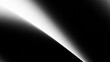 © adobe - A dark background with a white light beam shining diagonally across