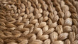 © wirachut - Close up of authentic woven natural fiber mat showing detailed texture and reality of handcrafted design in warm brown tones