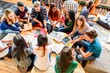 © Rawpixel.com - Diverse students collaborating in library.