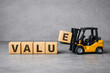 © Md Ikbal - A toy forklift places a block with the letter E to spell out the word VALUE.