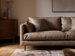 © FiligreeDigital - Luxurious and comfortable tan leather sofa in a modern living room setting with soft natural light