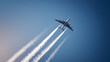 © A2Z AI  - Modern Commercial Aircraft Soar Upward into a Deep Blue Sky, Leaving White Contrail Trails, Symbolize Global Travel and Aspiration