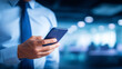 © kaliel - Businessman holding a smartphone in a modern office, representing mobile communication, productivity, and digital business workflow.