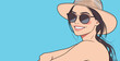 © hakule - Woman in hat and sunglasses smiles against blue background during sunny day
