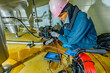 © chitsanupong - A man starts using a weld pipe stainless inspection camera. The light monitor shows images from the camera head
