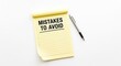 © Keo - A yellow notepad with the words 'MISTAKES TO AVOID' written on it lies on a white surface. A black pen rests beside the notepad.