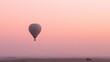 © zhou - detached. Hot air balloon ascending into a soft pink morning sky. mobility guides, transit brochures, designed for mobility and urban transit guides, improves user orientation.
