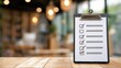 © huynh - Clipboard with a completed checklist standing on a wooden table in a blurred cafe background, representing remote work flexibility and successful lifestyle business management.