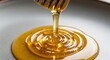 © asmi - Golden honey pouring from honey dipper.