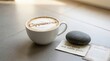 © KhairanHilmi - Cappuccino Coffee Cup With 'Inner Peace and Subtle Power' Message and Zen Stone on Surface