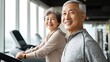 © Chumnan - Active Senior Couple in Gym: Capture a vibrant senior couple, glowing with health and happiness as they engage in a treadmill workout at the gym.