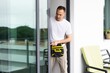 © Angelov - worker installing a balcony glass railling in an apartment
