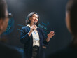 © Konstantin Yuganov - Confident Female Speaker Presenting at Business Seminar on Stage