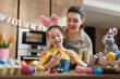 © Konstantin Yuganov - Mother and Daughter Enjoy Easter Egg Painting Celebration