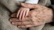 © Omishu Makes - Close up of deeply wrinkled elderly hands gently holding the tiny hand of a newborn baby, generational family legacy.