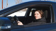 © fifthplanet - Happy young driver behind the wheel inside new car. Lifestyle scene inside the car