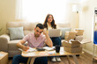 © AntonioDiaz - Couple working on side hustle, packaging and managing orders for their home-based e-commerce business