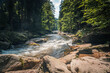 © petrsvoboda91 - Clear mountain river Orlice flowing between large rocks and dense green forest in Orlicke Mountains, Czech Republic, illuminated by warm summer sunlight in a peaceful natural landscape.