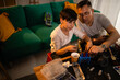 © Zoran Jesic - Father and son repairing remote control car hobby
