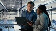 © DC Studio - Team of engineers monitor server hub activity using laptop and tablet. Teamworking data center colleagues review rigs tests results on devices to ensure systems are working correctly, camera B