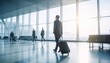 © Muhammad - A businessman with luggage strides through a modern, sunlit airport terminal, embodying the journey of professional ambition and global connection in a dynamic world