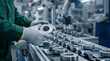 © Yudi - Industrial worker inspects a ball bearing on a factory assembly line. Precision manufacturing and quality control in action