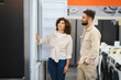 © Serhii - Couple exploring home appliances in electronics store