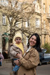 © phpetrunina14 - Mother holding toddler on city street in spring Portrait