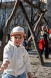 © phpetrunina14 - Toddler in white hoodie at playground on sunny day Portrait