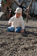 © phpetrunina14 - Toddler playing on gravel playground in sunny park Portrait