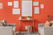 © Pixel-Shot - Interior of stylish living room with grey sofas, table and frames hanging on orange wall