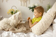 © Tomsickova - Cute little preschool boy with his pet dog, playing together in bed