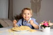 © Tomsickova - Cute preschool child, blond boy, eating spaghetti at home, making a mess everywhere
