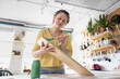 © ReeldealHD images - Young Woman Painting a shelf in her cosy kitchen